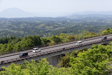 Road Landscape in Kirishima Shinwa no Sato Park, Kyushu, Japan, Showing the Fusion of Mountain Forest Road and Distant Mountains in Natural Scenery