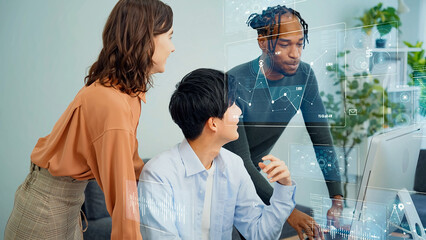 Multinational group having a conversation in an office with digital technology