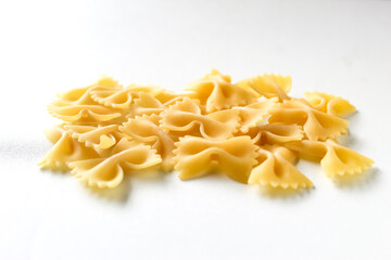 raw farfalle pasta isolated on white background