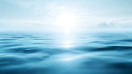 Fototapeta premium Gentle ocean waves reflect a bright, hazy sky.