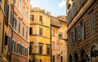 Colorful historic buildings with shuttered windows in narrow European street in Rome