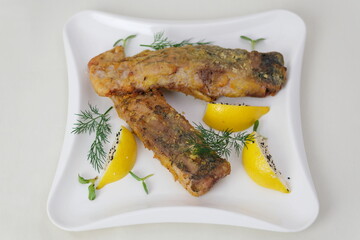 Fried fish lemons breaded fish with dipping sauce and lemon