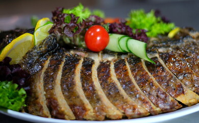 stuffed fish Delicious stuffed carp with lemon and lettuce leaves.