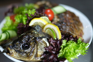 stuffed fish Delicious stuffed carp with lemon and lettuce leaves.