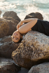 Young woman enjoys sunny day by the ocean in Miami beach