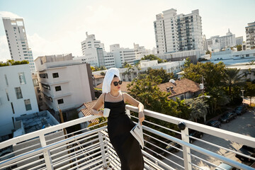 Chic summer day on a Miami rooftop with a stylish woman and stunning views