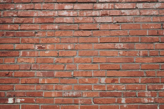 Crimson masonry facade with linear patterns