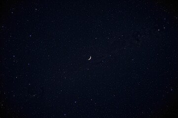 Authentic night sky showcasing stars and a crescent moon