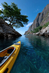 A kayak glides through the serene waters of a cove, surrounded by towering cliffs and lush greenery, epitomizing adventure and the peacefulness of nature.