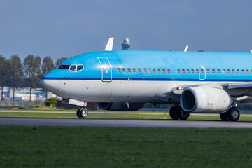 Passenger airplane taxiing on the runway at Amsterdam Schiphol Airport