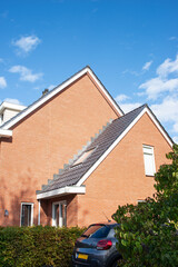 The architecture of modern building of typical red brick cottage on the street in a European city