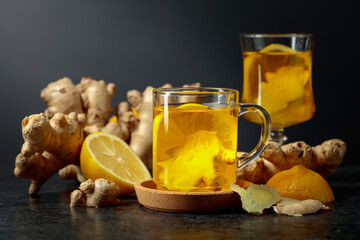 Ginger tea with lemon on a black background.