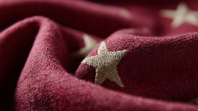 Rustic crimson fabric adorned with faded stars, evoking vintage Americana vibes, perfect for Flag Day or quilted nostalgia