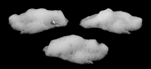 Collection of white soap foam or bubbles isolated on black background, abstract texture design for...