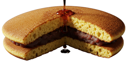 Close-up of traditional Japanese Dorayaki dessert sliced open with sweet red bean paste filling isolated PNG with Transparent Background