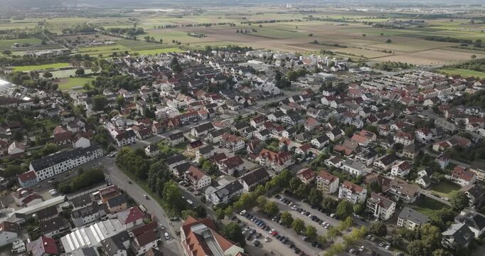 Aerial view of Schriesheim reveals a tapestry of red-tiled roofs, lush greenery, and orderly streets, blending urban life with the serenity of nature, Schriesheim, Baden-Wurttemberg, Germany.