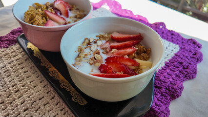 Yogurt with nuts, cereal, strawberry and apple
