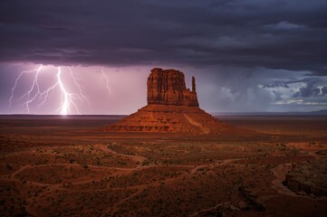 Lightning Hits a Prominent Butte in a Desert Valley