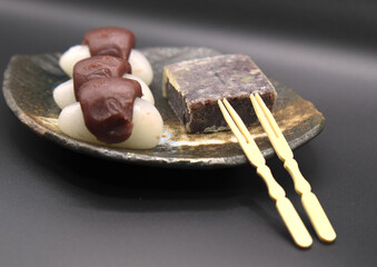 raditional Japanese Mochi with Anko (Red Bean Paste) and Yokan on a Ceramic Plate