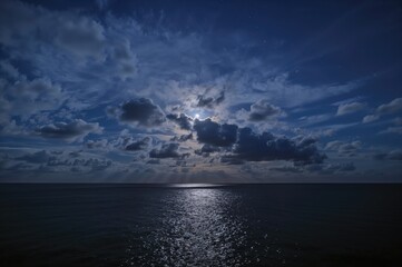 Lunar glow illuminating a stormy ocean night