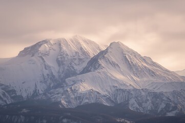 Stunning snowy peak beneath a soft misty sky