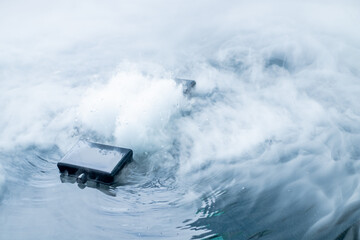 Fog Generator is modern technology device submerged in water with steam and bubbles rising,...