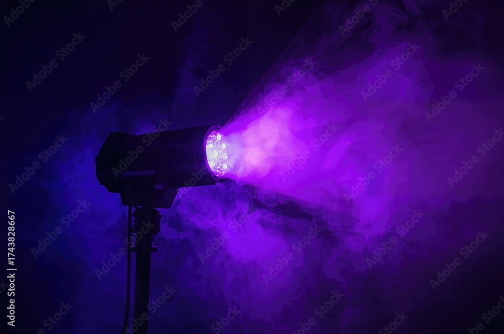 Wall mural modern led party light casting purple rays, colorful spotlight moving side to side in a dim space.