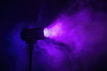 Modern LED party light casting purple rays, colorful spotlight moving side to side in a dim space.