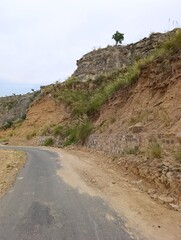 Road through the mountains with Greenery under Blue sky