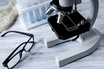 doctors desk with microscope and test tubes