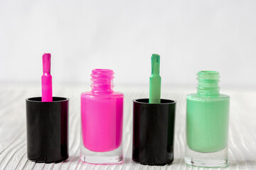 open bottles of nail polish on wooden background
