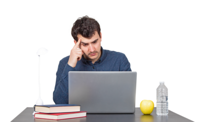 Puzzled young man seated at the working desk looking pensive in his laptop. Hard thinking, fatigue male isolated portrait on transparent background