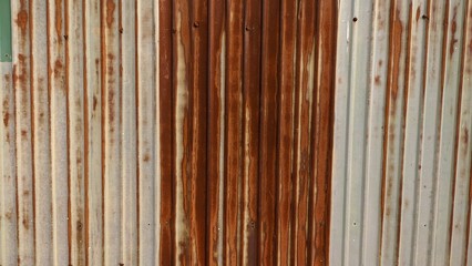Old and rusty galvanized sheet metal wall, abstract rust pattern.