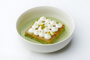 Gourmet Pistachio Milk Cake with Cream and Pistachio Garnish