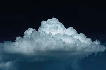 White clouds set against a dark backdrop