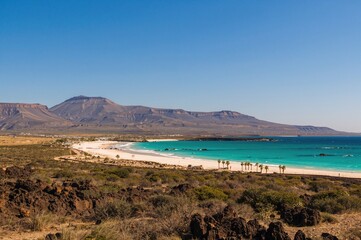 Fototapeta premium Northern Fuerteventura's Corralejo Flag Beach, Isla de Lobos, and surrounding mountains visible