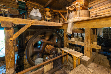 Historical Kvacany water mill interior showing machinery working