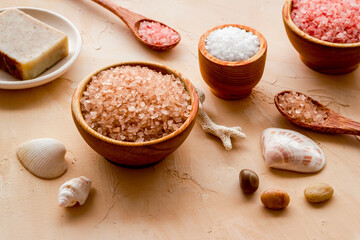 Spa treatment body care cosmetics close up. Sea salt in bowls and soap with sea shells
