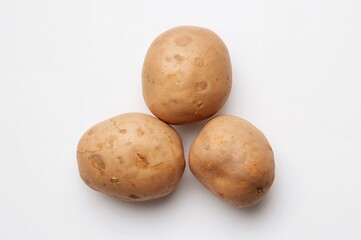 Fototapeta premium Three Individual Potatoes Against a White Backdrop