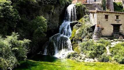 Aerial view of little town and the beautiful waterfall of Orbaneja del Castillo in Burgos, Spain.