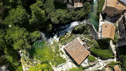 Aerial view of little town and the beautiful waterfall of Orbaneja del Castillo in Burgos, Spain.
