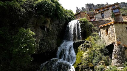 Aerial view of little town and the beautiful waterfall of Orbaneja del Castillo in Burgos, Spain.