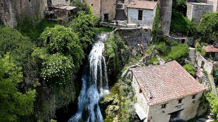 Aerial view of little town and the beautiful waterfall of Orbaneja del Castillo in Burgos, Spain.