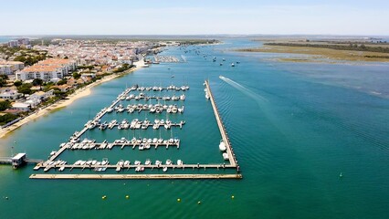 Aerial view over the village, marinas and fishing port of Punta Umbría, and the river Piedras, in the Atlantic coast of Huelva, Andalusia, Spain.