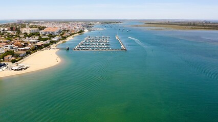 Aerial view over the village, marinas and fishing port of Punta Umbría, and the river Piedras, in the Atlantic coast of Huelva, Andalusia, Spain.