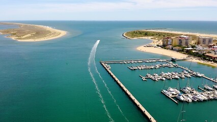 Aerial view over the village, marinas and fishing port of Punta Umbría, and the river Piedras, in the Atlantic coast of Huelva, Andalusia, Spain.