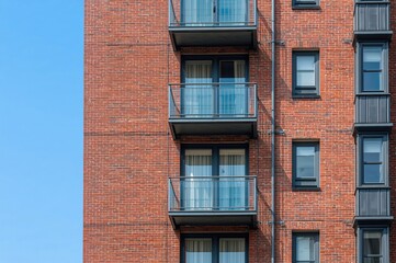 Obraz premium Exterior of a contemporary apartment featuring red brick architectural details