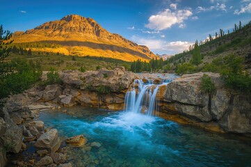 Scenic Waterfall Amidst Rocky Terrain and Natural Beauty