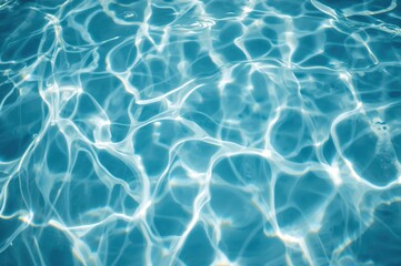 Fototapeta premium Aerial perspective of a vacant pool's water surface with shimmering reflections and gentle waves, softly blurred for an abstract effect.
