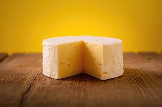 Caucasian style smoked Chechel cheese as a delicious beer accompaniment on a wooden table